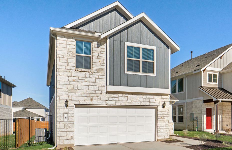 Front exterior of a new home in Santa Rita Ranch, Liberty Hill, TX, highlighting curb appeal (Image 22).