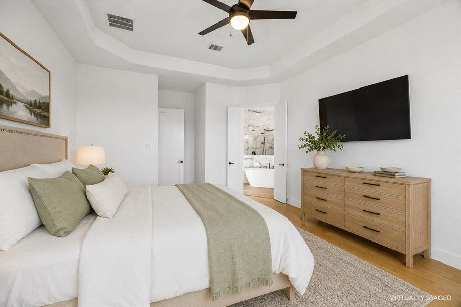 The primary suite is tucked away in the back of the home and creates the perfect peaceful retreat.