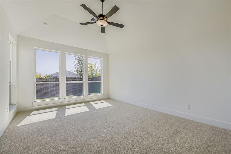 Spare room with light carpet, a ceiling fan, and high vaulted ceiling Spare room with light carpet, a ceiling fan, and high vaulted ceiling