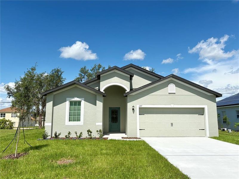 Front exterior of a new home in Poinciana, Poinciana, FL, highlighting curb appeal (Image 1). Front exterior of a new home in Poinciana, Poinciana, FL, highlighting curb appeal (Image 1).