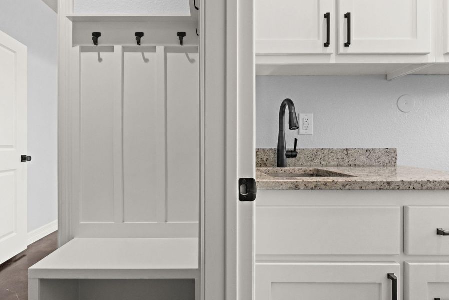 Mudroom featuring a sink and a textured wall