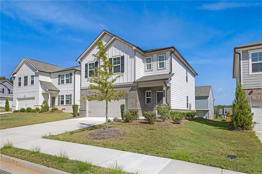 Front exterior of a new home in , Douglasville, GA, highlighting curb appeal (Image 2). Front exterior of a new home in , Douglasville, GA, highlighting curb appeal (Image 2).