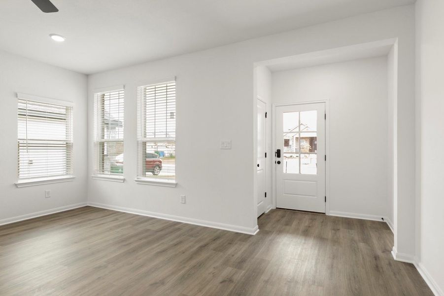Entryway featuring healthy amount of natural light, dark wood-style flooring, a ceiling fan, and recessed lighting