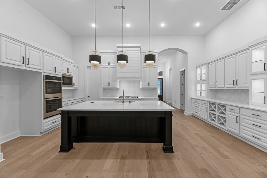 Ample prep and storage space. Kitchen includes a walk-in pantry, quartz counters, and oversized island. Ample prep and storage space. Kitchen includes a walk-in pantry, quartz counters, and oversized island.