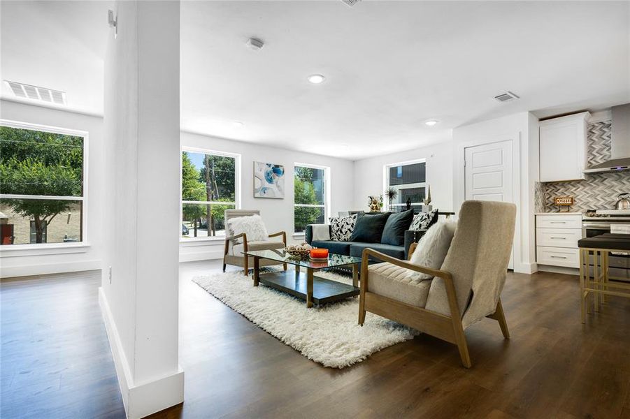 Living room featuring dark hardwood / wood-style floors and a wealth of natural light