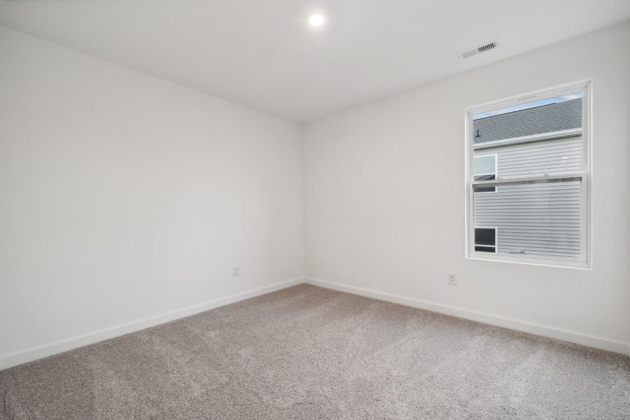 A room with a window and a carpet. A room with a window and a carpet.