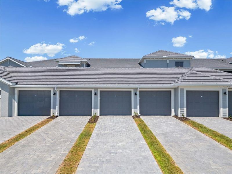 Front exterior of a new home in Calusa Country Club, Lakewood Ranch, FL, highlighting curb appeal (Image 2).