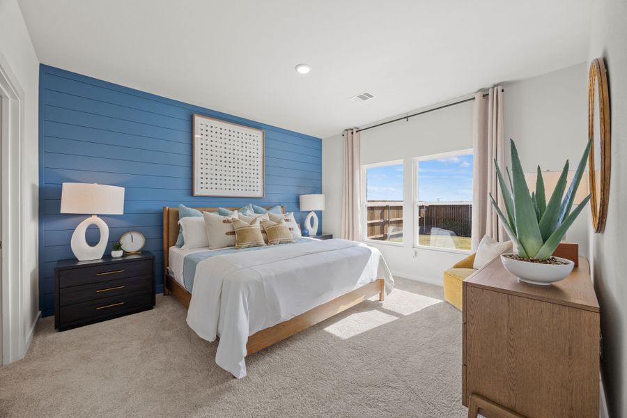 A bedroom with a bed and a table. A bedroom with a bed and a table.