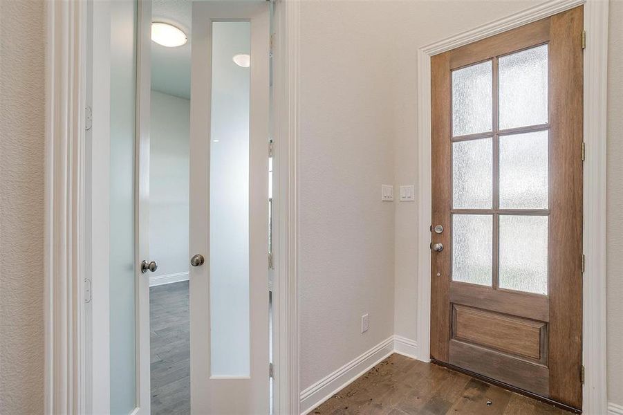 Entrance foyer with dark hardwood / wood-style flooring