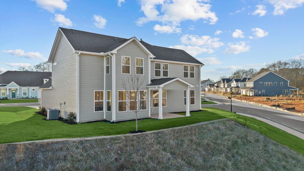 Exceptional outdoor living begins with a covered back porch in this thoughtfully designed home