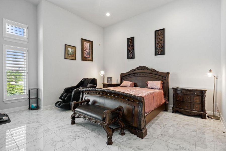 Bedroom with recessed lighting and light marble finish flooring