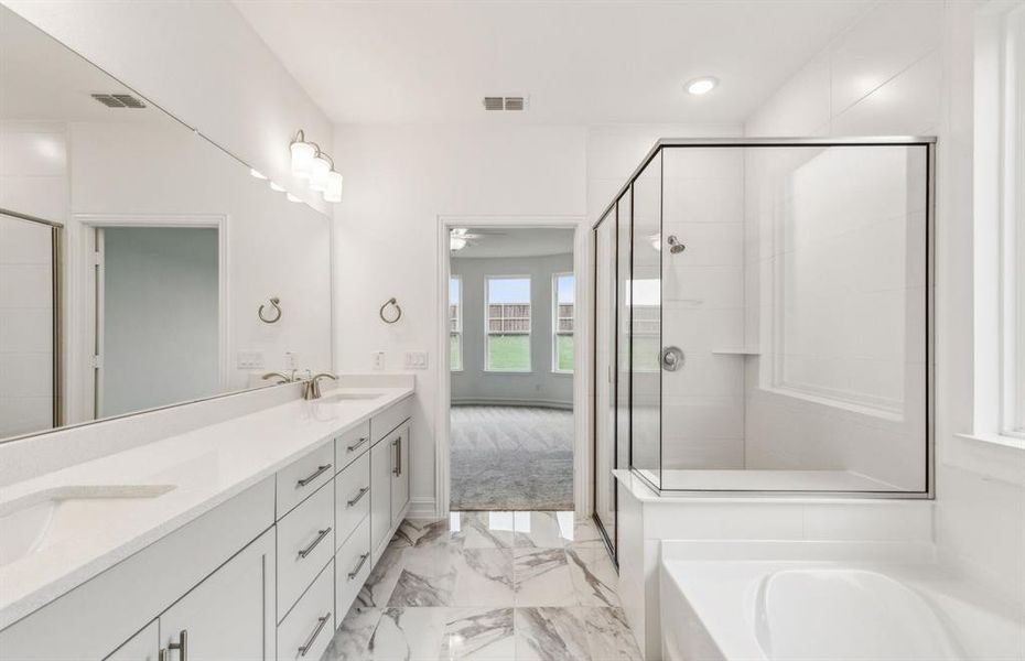 Private owner's bathroom with dual vanity and oversized shower*real home pictured