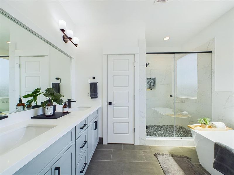 Primary Bathroom features a gorgeous freestanding tub and a separate shower with semi-frameless glass shower door. Photos from another development by Disama Construction. FINISHES & COLORS MAY VARY.