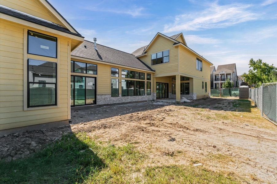 Expansive backyard features a pavilion and courtyard and has room for a pool!