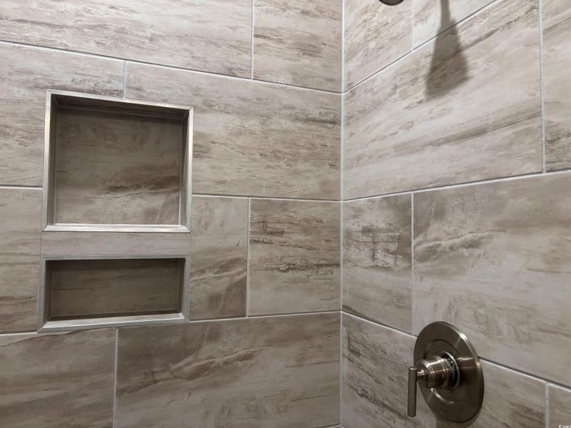 Bathroom view of a tile shower