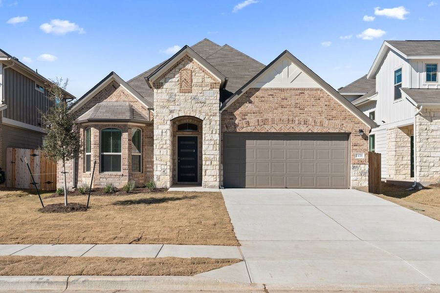 Front exterior of a new home in The Hills of Bear Creek, Manchaca, TX, highlighting curb appeal (Image 4).