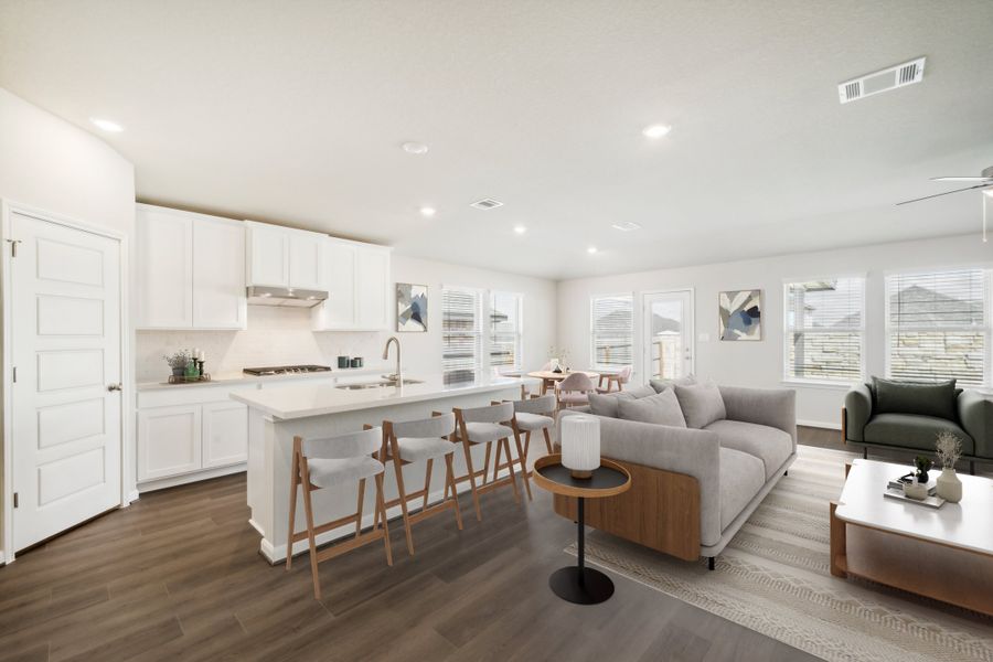 Virtually staged kitchen and living room in the Fitzhugh floorplan in a Meritage Homes community.