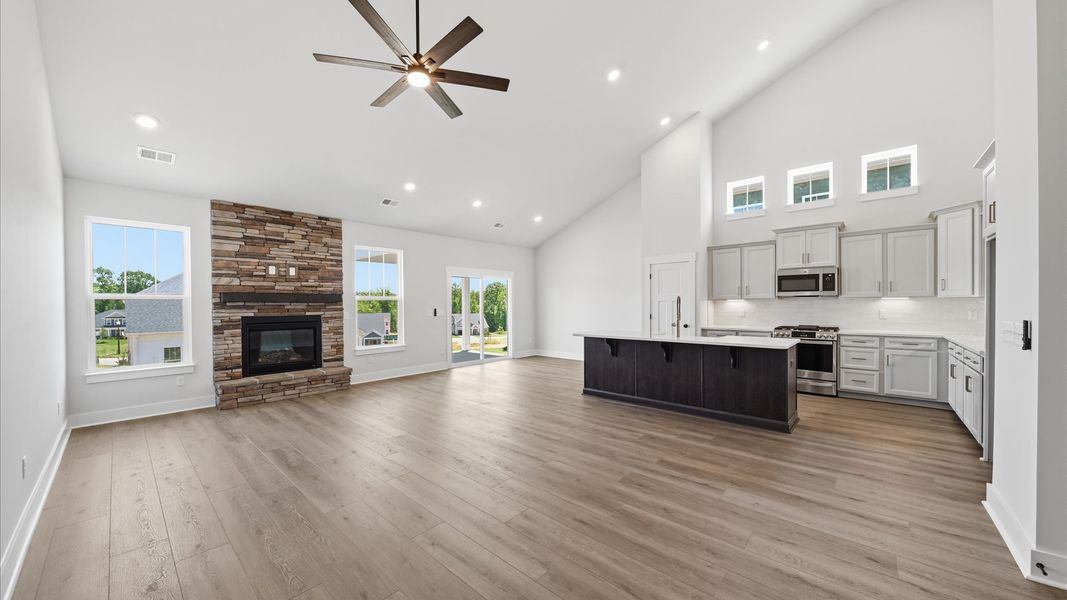 Highly skilled craftsmanship and modern elegance meet in this family room with soaring ceilings in Moore, SC