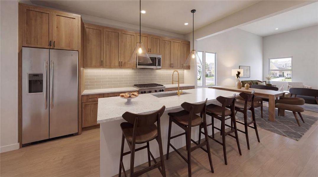 Open-concept kitchen featuring wood-finish cabinetry, stainless steel appliances, a center island with bar seating, and light-toned flooring Open-concept kitchen featuring wood-finish cabinetry, stainless steel appliances, a center island with bar seating, and light-toned flooring