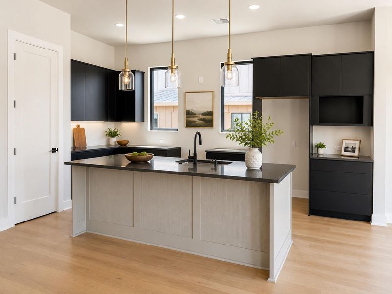 A well-appointed kitchen showcasing a spacious island, rich dark cabinetry, and elegant pendant lighting.