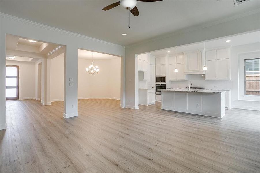 Kitchen featuring appliances with stainless steel finishes, light wood-type flooring, and a wealth of natural light