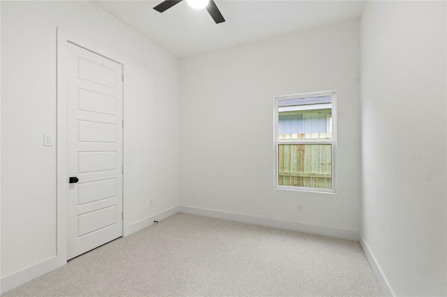 Spare room featuring ceiling fan, carpet flooring, and baseboards