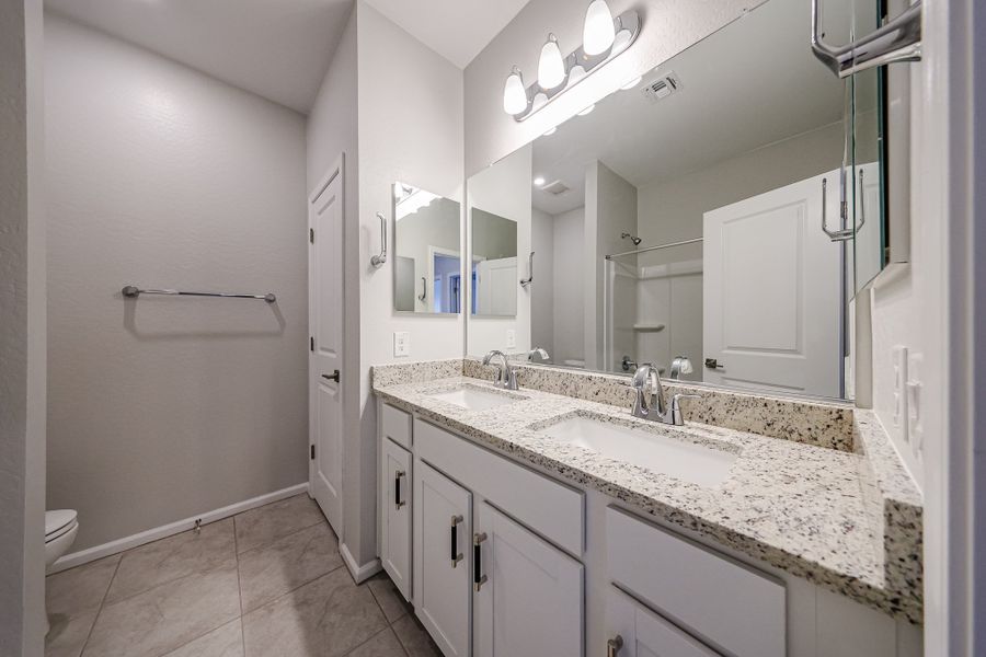 A bathroom with a large mirror.