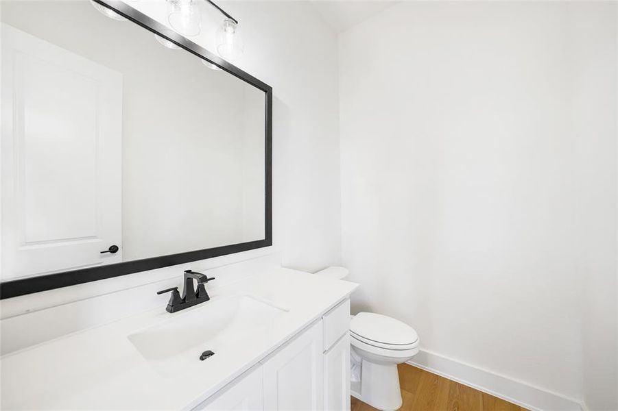 Bathroom featuring wood finished floors and vanity