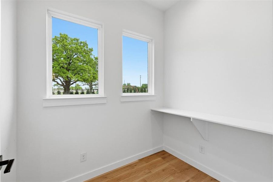 Spare room featuring light wood-style floors and baseboards