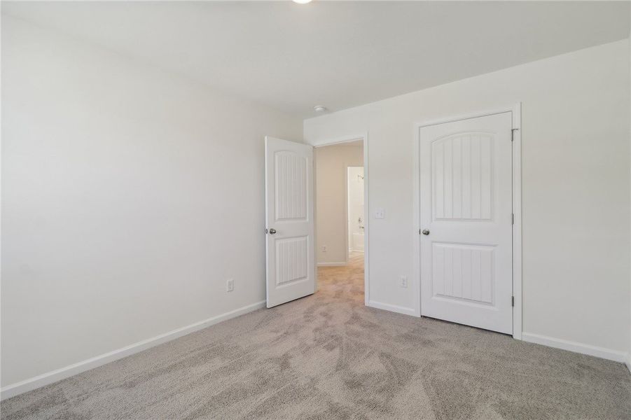 This spacious bedroom offers comfortable carpeting This spacious bedroom offers comfortable carpeting