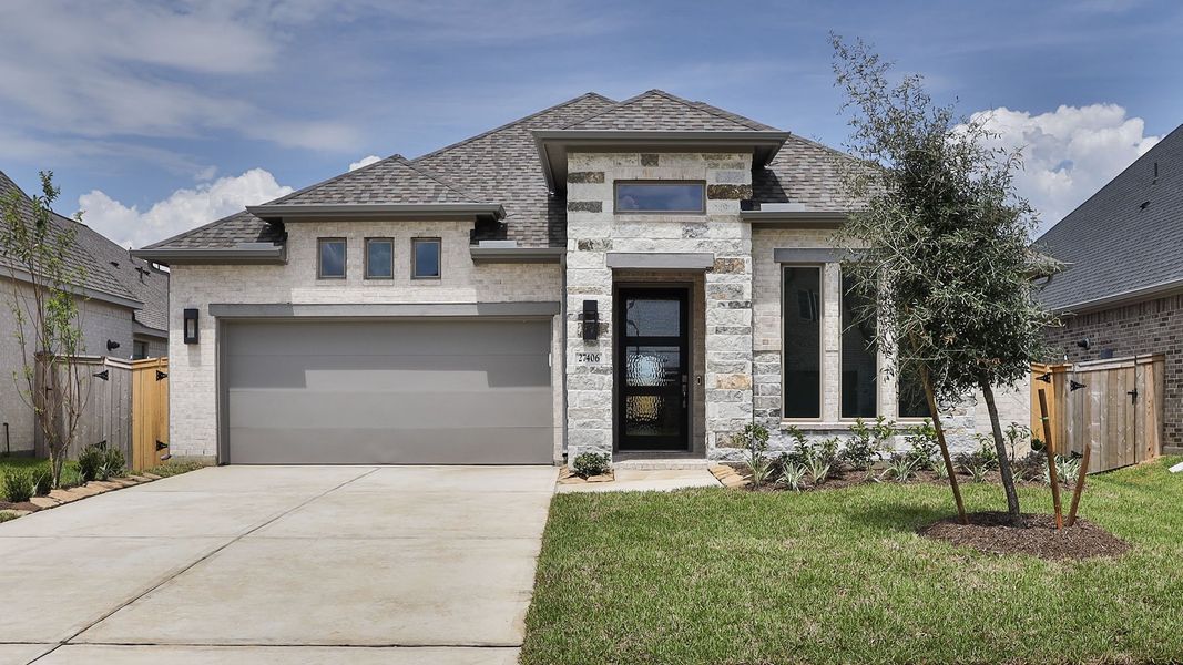 Front exterior of a new home in The Grand Prairie, Hockley, TX, highlighting curb appeal (Image 1). Front exterior of a new home in The Grand Prairie, Hockley, TX, highlighting curb appeal (Image 1).