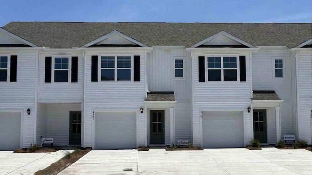 Front exterior of a new home in The Landing at Sidbury Station, Castle Hayne, NC, highlighting curb appeal (Image 1). Front exterior of a new home in The Landing at Sidbury Station, Castle Hayne, NC, highlighting curb appeal (Image 1).