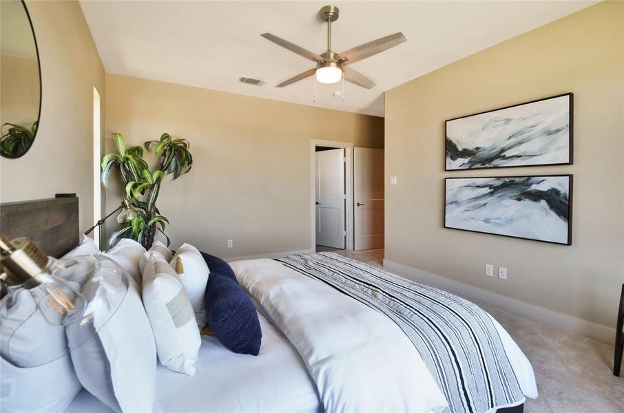 Carpeted bedroom featuring baseboards and ceiling fan