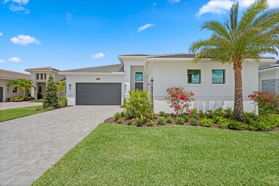 Front exterior of a new home in Cresswind Palm Beach at Westlake, Westlake, FL, highlighting curb appeal (Image 29). Front exterior of a new home in Cresswind Palm Beach at Westlake, Westlake, FL, highlighting curb appeal (Image 29).