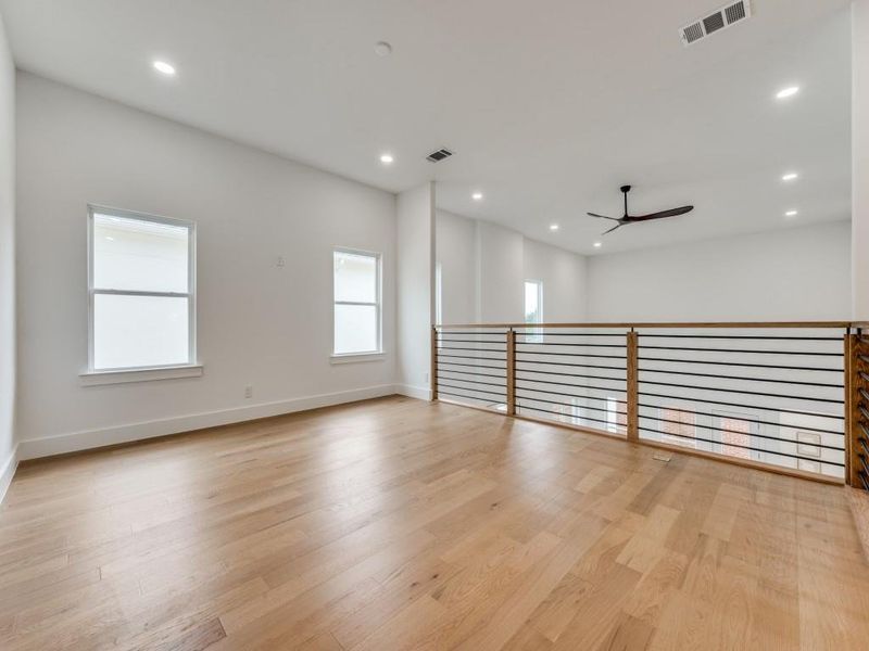 Empty room featuring ceiling fan and light hardwood / wood-style flooring