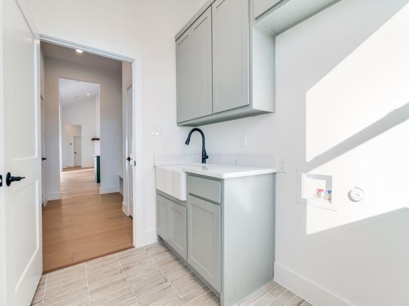 Laundry room with light tile patterned floors, hookup for a washing machine, cabinet space, and recessed lighting