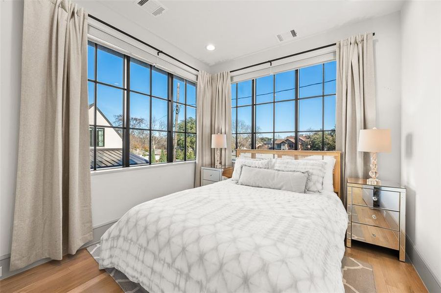 Guest house bedroom with oak hardwood floors and recessed lighting