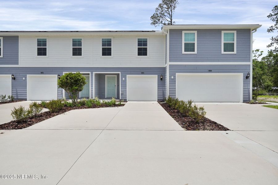 Front exterior of a new home in Normandy Pines, Jacksonville, FL, highlighting curb appeal (Image 1). Front exterior of a new home in Normandy Pines, Jacksonville, FL, highlighting curb appeal (Image 1).