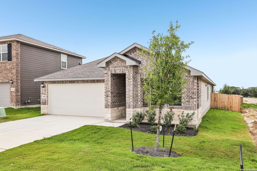 Front exterior of a new home in Thomas Pond, San Antonio, TX, highlighting curb appeal (Image 2). Front exterior of a new home in Thomas Pond, San Antonio, TX, highlighting curb appeal (Image 2).