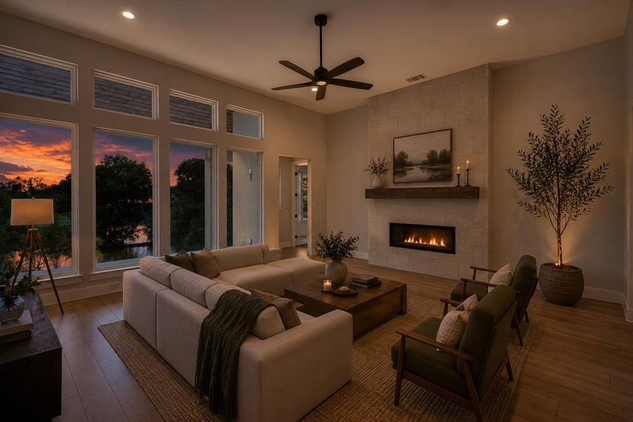 A comforting living space with a modern fireplace and impressive water views from extensive windows.