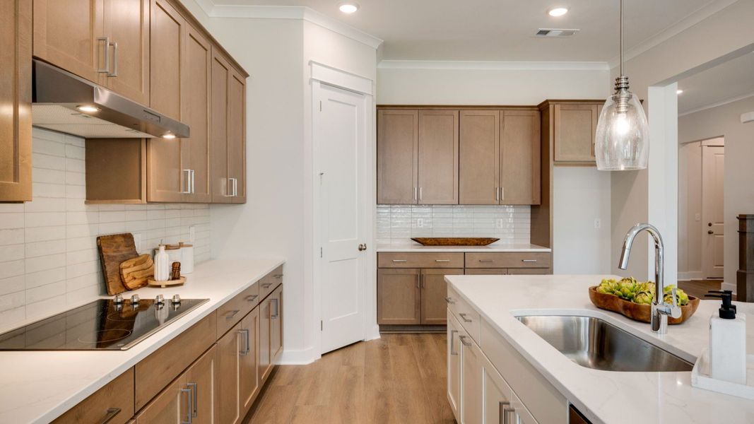 Sink and dishwasher paired with kitchen island next to staircase Sink and dishwasher paired with kitchen island next to staircase