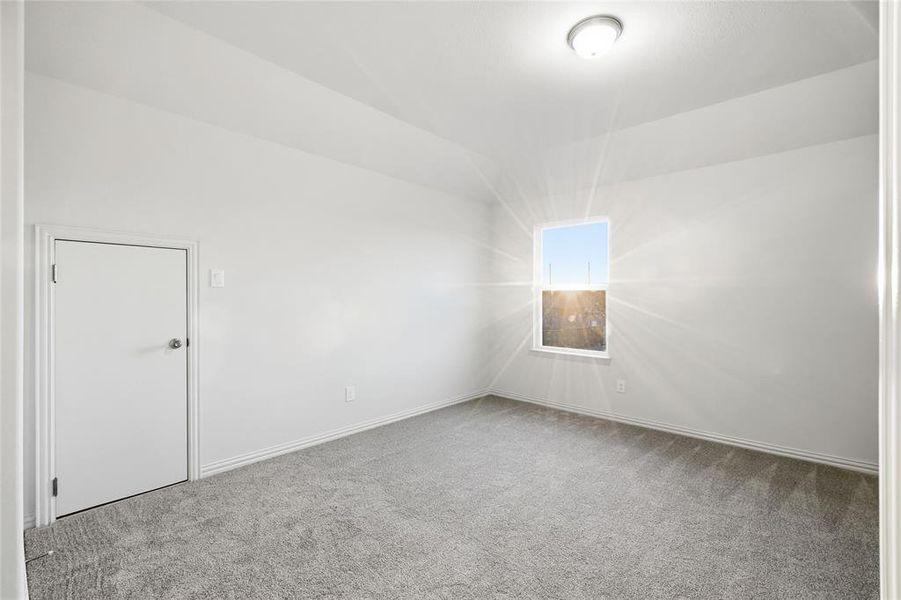 Empty room with carpet and baseboards