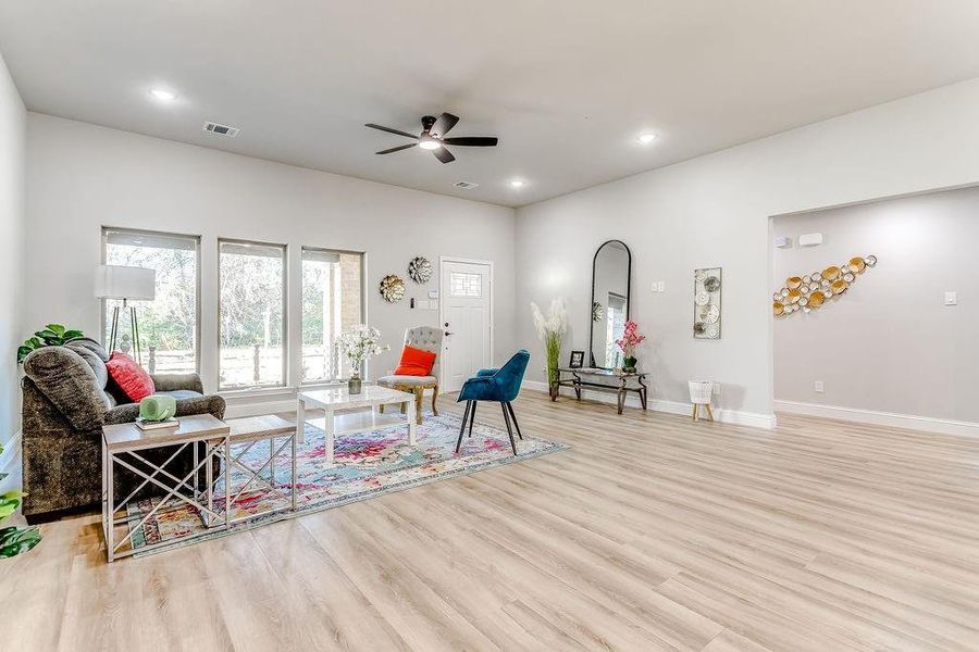 Living room featuring ceiling fan and light wood-type flooring