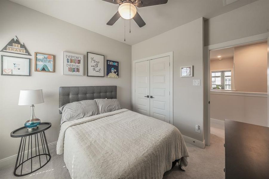 Bedroom with carpet flooring, a closet, and ceiling fan
