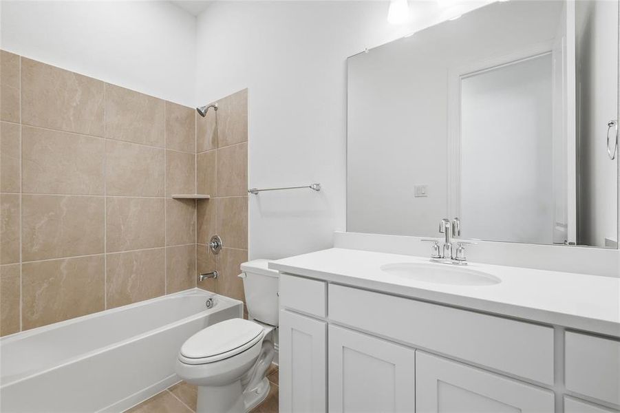 Bathroom with tub / shower combination, vanity, and light tile patterned flooring Bathroom with tub / shower combination, vanity, and light tile patterned flooring