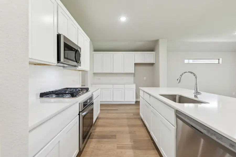 Kitchen in the Heisman home plan by Trophy Signature Homes – REPRESENTATIVE PHOTO