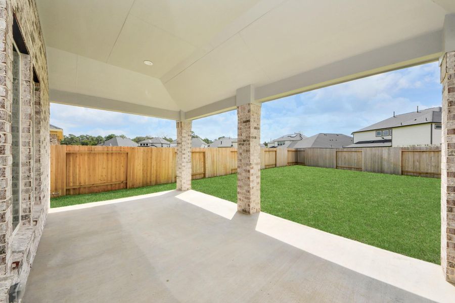 Experience outdoor living at its finest on this expansive covered patio, thoughtfully designed for BBQs and delightful outdoor dining.