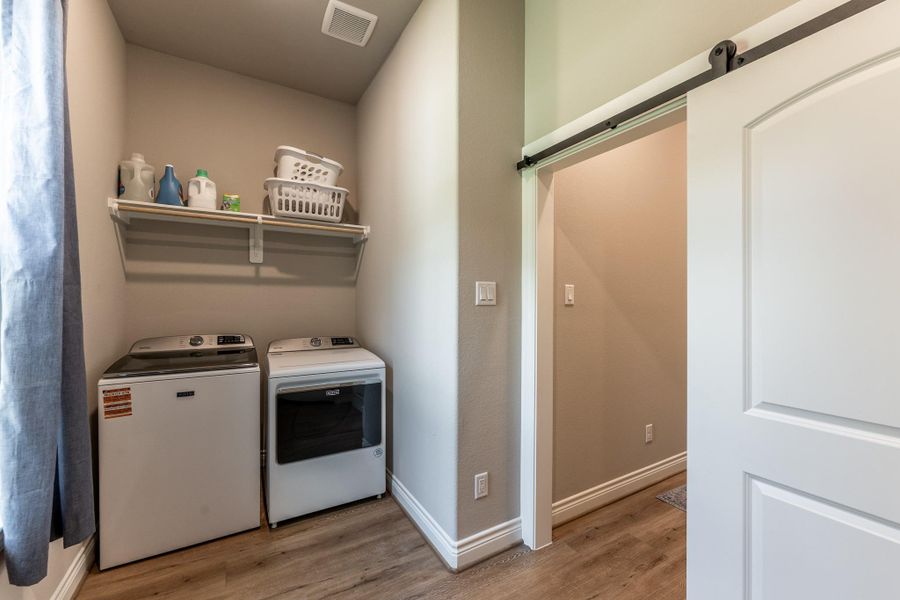 Barn door to shut off laundry - additional half bath just around the corner