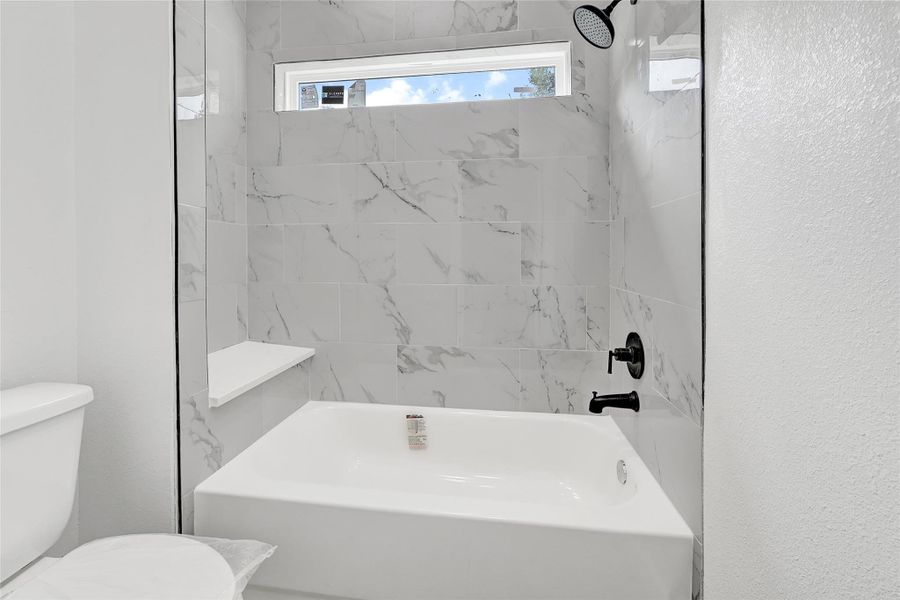 Frameless glass shower with floor-to-ceiling tile. Frameless glass shower with floor-to-ceiling tile.