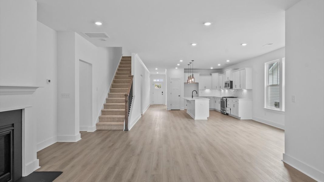 Elegant family room with hardwood flooring, fireplace, and open-concept flow in this first-class DRB Homes design Elegant family room with hardwood flooring, fireplace, and open-concept flow in this first-class DRB Homes design